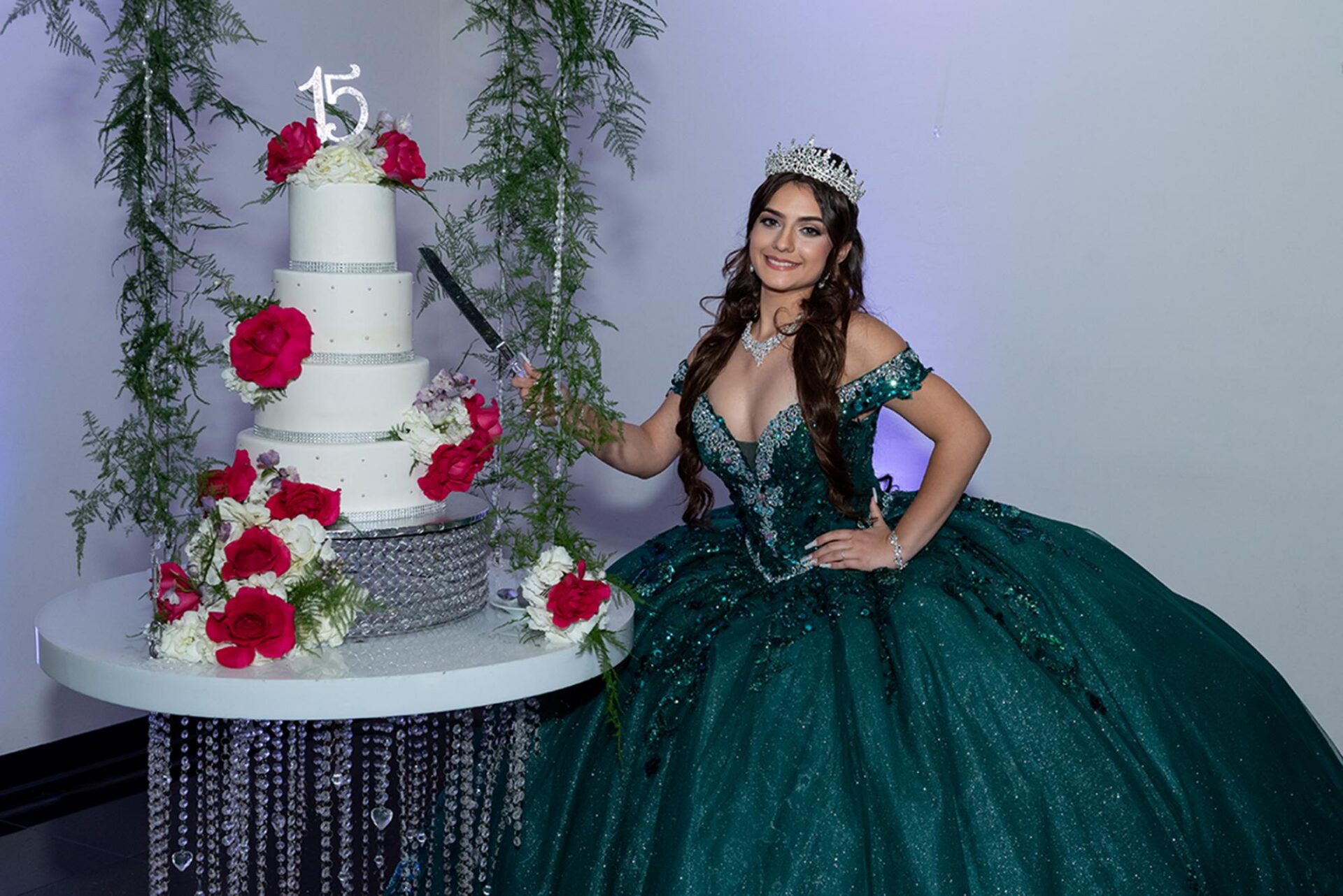 Quinceañera portrait with cake photographed at Aqua Reception Hall